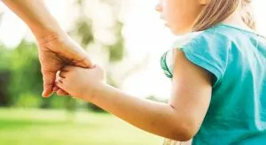 mom holding hands with child